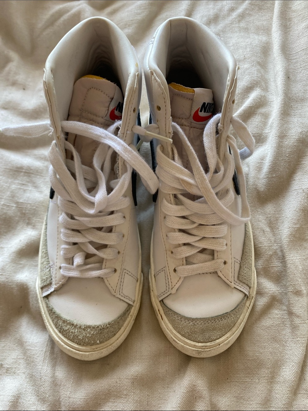 Nike White High-Top Sneakers with Black Swoosh and Yellow Tongue Detail